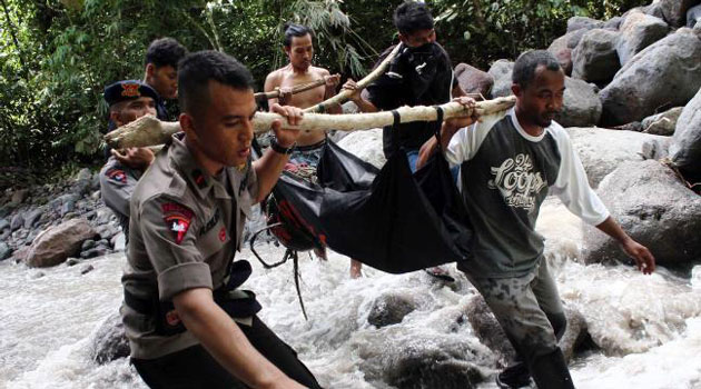 In one district, five people were buried in their homes as a landslide swept through the village. In another, nine people were killed as they tried to clear rubble from a road/AFP