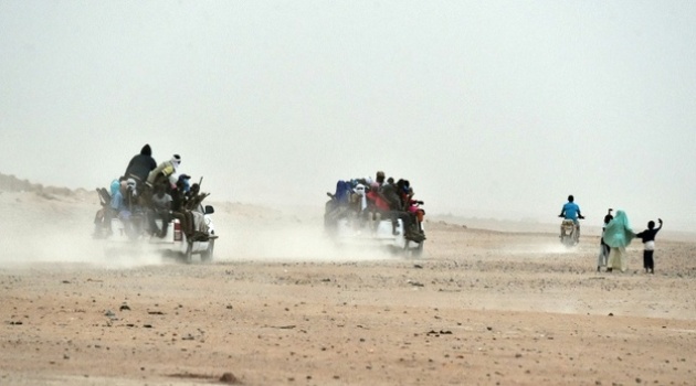 Migrants on pick-up trucks leave the outskirts of Agadez, Niger, heading across the Niger desert towards Libya and, ultimately, Europe/AFP-File