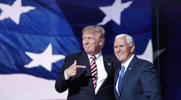 Republican presidential candidate Donald Trump, points toward Republican vice presidential candidate Indiana Gov. Mike Pence after Pence's acceptance speech during the third day session of the Republican National Convention in Cleveland/AFP