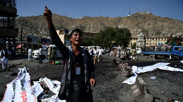 A protester screams near the scene of a suicide attack that targeted crowds of minority Shiite Hazaras during a demonstration at the Deh Mazang Circle in Kabul on July 23, 2016/AFP