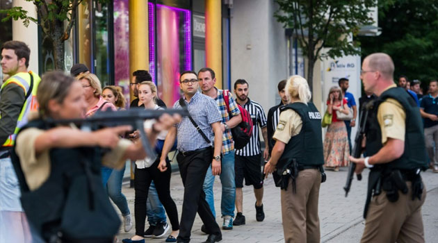 Shoppers rushed away from the Olympia Einkaufzentrum (OEZ) shopping mall in Munich as the building was surrounded by armed police and emergency vehicles/AFP