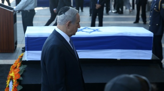 Israeli Prime Minister Benjamin Netanyahu walks past the coffin of former Israeli president Shimon Peres at the Knesset, Israel's Parliament, in Jerusalem/AFP