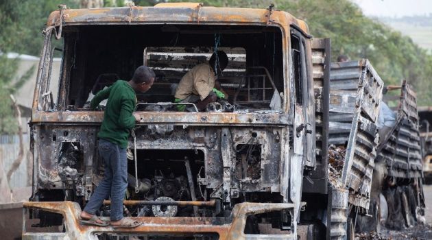 Children explore the remains of a cargo truck in Sebeta, central Ethiopia on October 13, 2016 after protesters took to the street to vandalise property thought to belong to the government/AFP