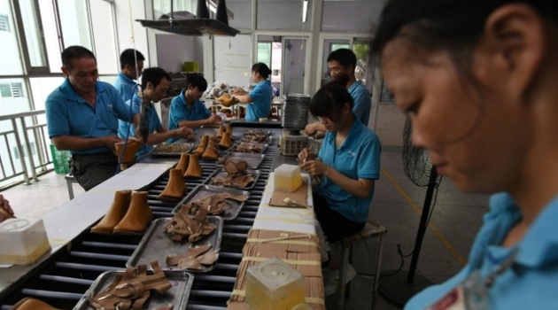 Workers on a production line at the Huajian factory where Trump-branded shoes have been made over the years in Dongguan, in south China/AFP