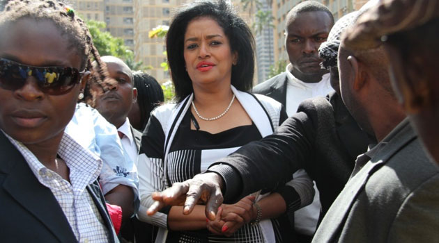 Passaris accompanied by her security detail outside the Milimani Law Courts/COURTESY