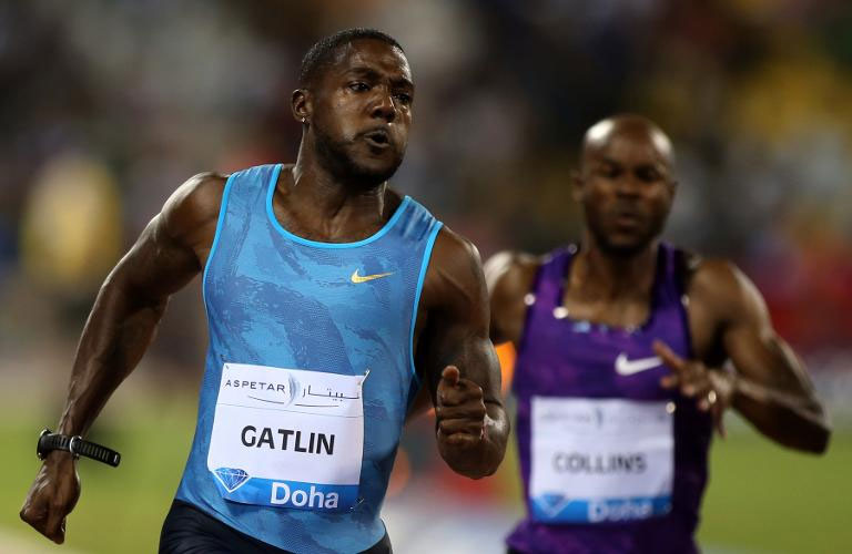 Justin Gatlin (L) sprints to win the 100m men's race at the Diamond League athletics meeting in Doha on Friday.