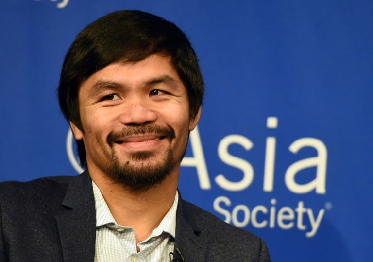Boxer Manny Pacquiao speaks to reporters after touring the Asia Society in New York, on October 12, 2015. PHOTO/AFP