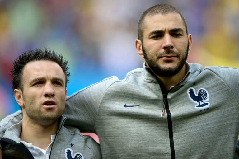 Mathieu Valbuena (left) and Karim Benzema listen to the French national anthem before the 2014 World Cup match against Nigeria in Brasilia. PHOTO/AFP