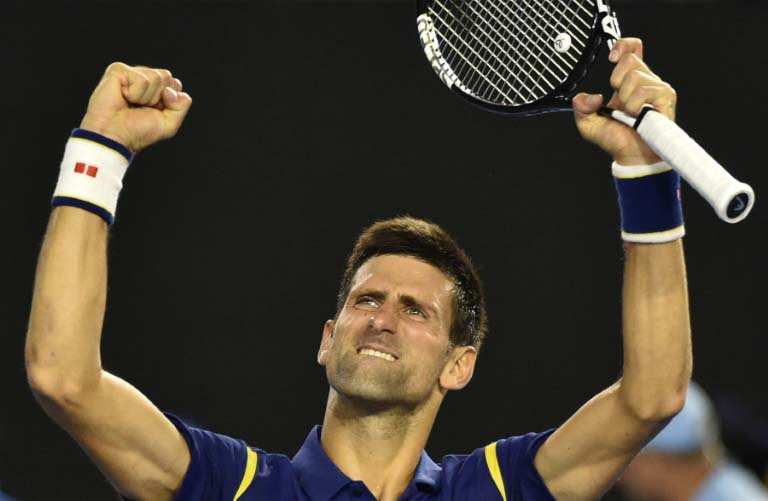 Serbia's Novak Djokovic celebrates after reaching his 19th Grand Slam final following his 6-1, 6-2, 3-6, 6-3 victory over Switzerland's Roger Federer at the Australian Open in Melbourne, on January 28, 2016. PHOTO/ AFP