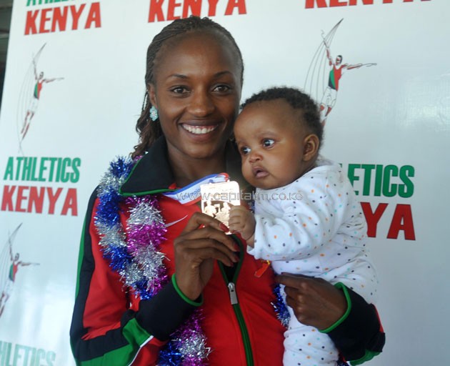 World Half Marathon bronze medalist Mary Wacera with her daughter when the victorious team arrived from Cardiff on Monday, March 28, 2016.PHOTO/Raymond Makhaya.