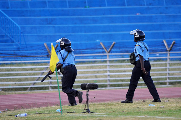 Police Officers lobbying teargas canisters to fans during Harambee Stars' 2017 AFCON Qualifier match against Guinea Bissau at Nyayo National Stadium on Sunday, March 27, 2016.PHOTO/Raymond Makhaya.