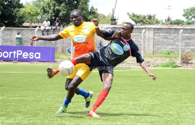 Muhoroni left back Godfrey Masinde vies for the ball with Thika's John Ayire/ PHOTO- Timothy Olobulu