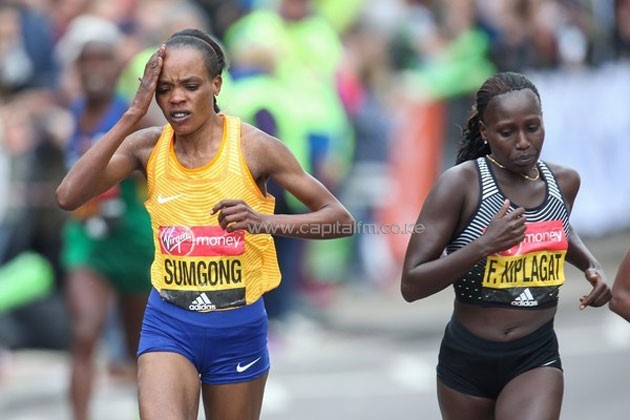 Sumgong clutches on her head after taking a tumble at the 35km mark. She soldiered on to win the race/PHOTO-Organisers