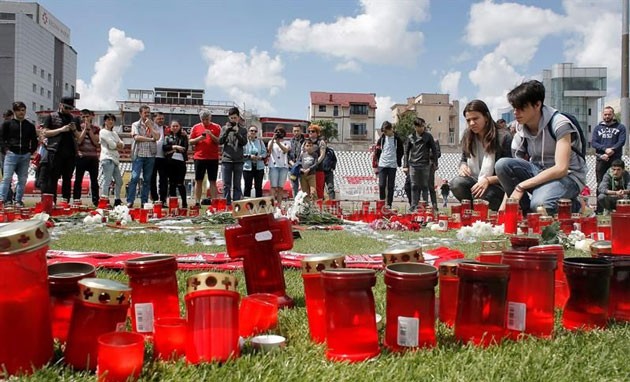 Dinamo Bucharest supporters light candles to pay their respect to Dinamo's Cameroonian midfielder Patrick Claude Ekeng at the Dinamo Stadium in Bucharest, Romania, 07 May 2016.