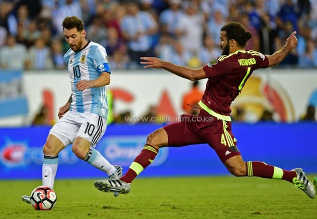 Argentina's Lionel Messi (L) fights for the ball with Venezuela's Oswaldo Vizcarrond- PHOTO/DailyMail