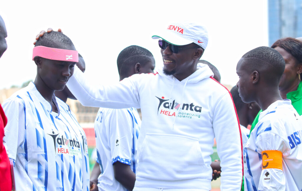 Sports CS Ababu Namwamba shares a word with Busia's Sharon Vidah before the opening match of the Talanta Hela U19 tournament. PHOTO/Timothy Olobulu
